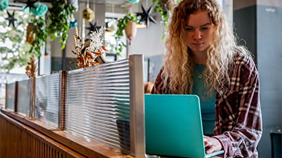 Student using laptop in a cafe