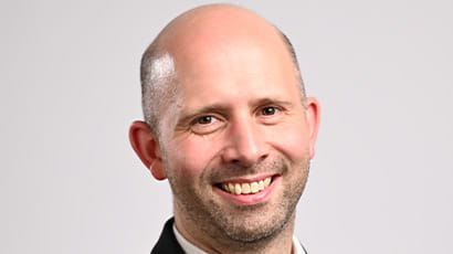 A man smiles at the camera