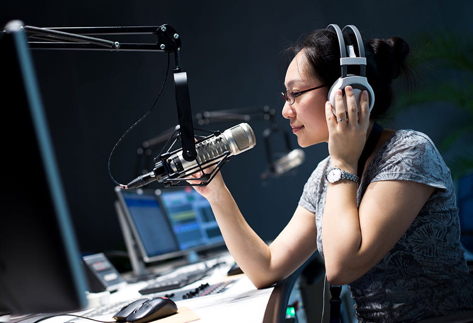 Journalism student using audio equipment.