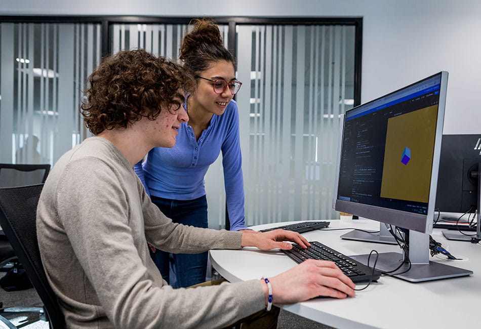 Two students looking at a computer screen.