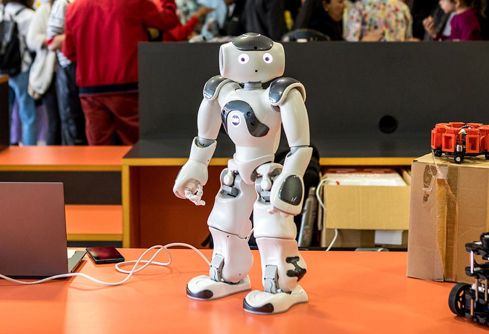 A small robot being display on a table.