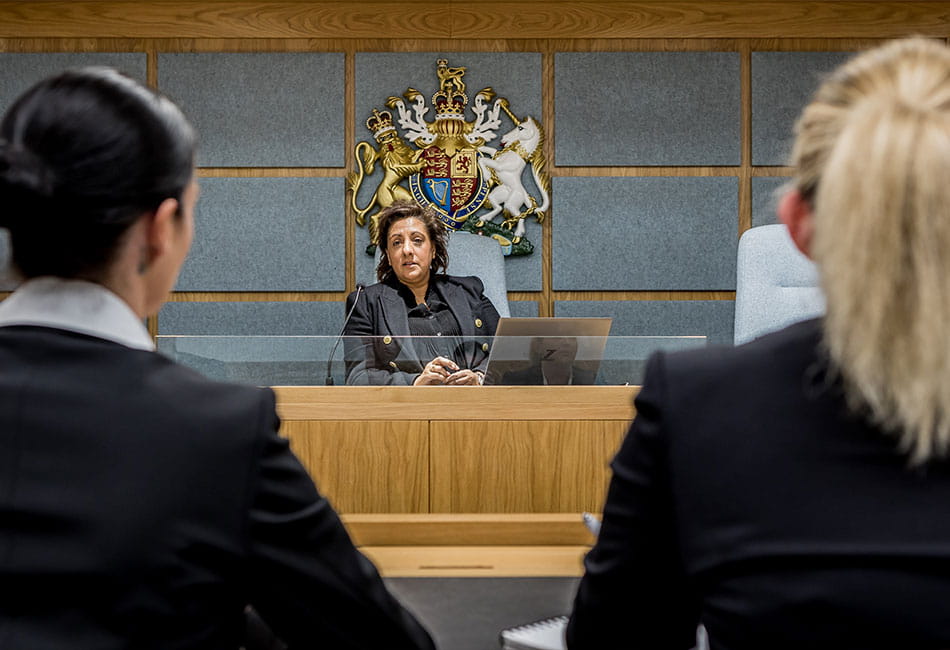 Students facing the judge as they practice a hearing in a mock court.