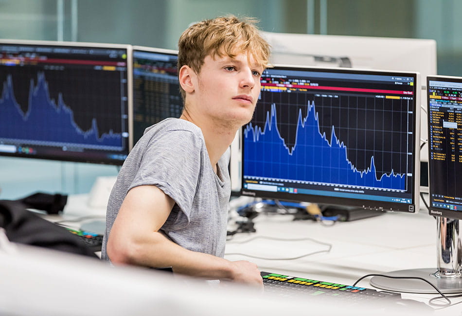 A student analysing stock market graph and data.