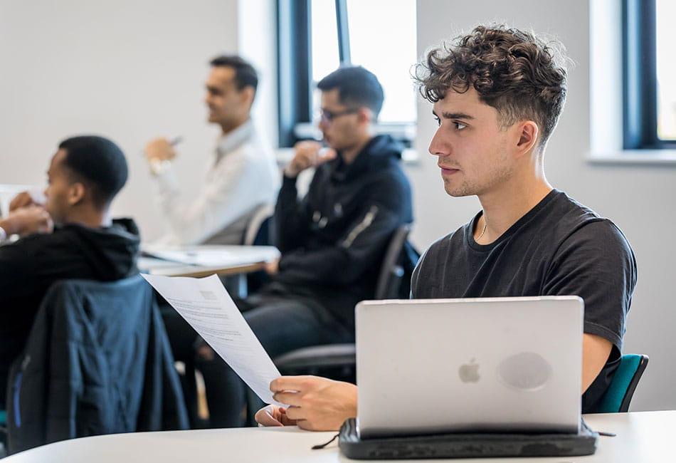 A group of students attending a lecture in a classroom.