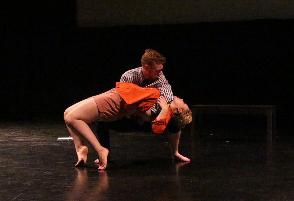 Two dancers performing a contempory dance on stage.