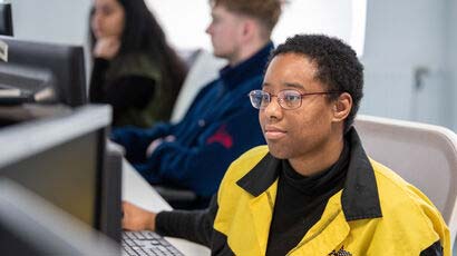 Student looking at a computer.