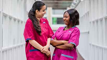 Healthcare students smiling at each other.