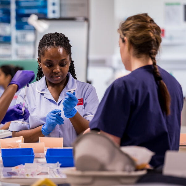 A nursing student being trained by a lecturer.