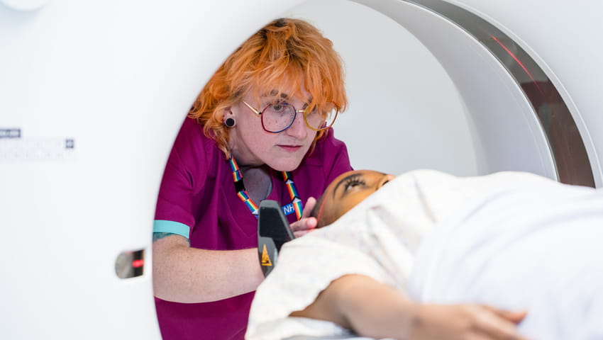 A nurse preparing a patient for a CT scan.