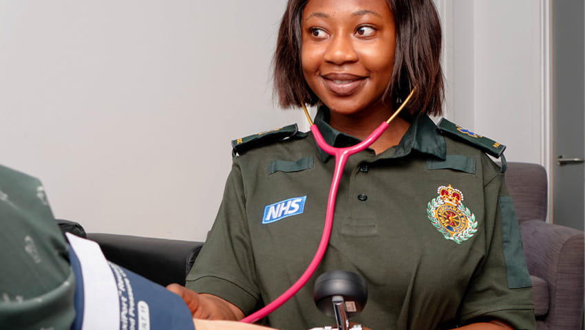 A paramedic measuring a patient’s blood pressure.