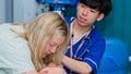 A nurse offering support and care to a patient.