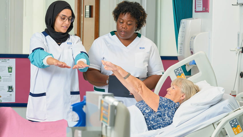 Two nurses assessing a patient.