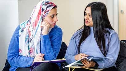 A couple of women sat with each of making notes