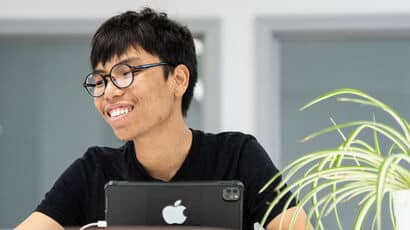 Smiling student with his laptop.