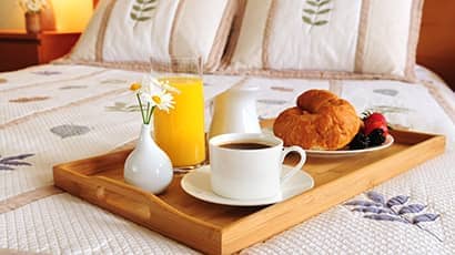 A breakfast tray on a double bed