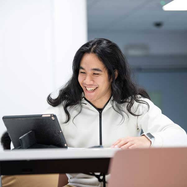Smiling man looking at a tablet