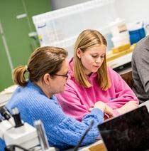 Student sat with mentor who is giving guidance.