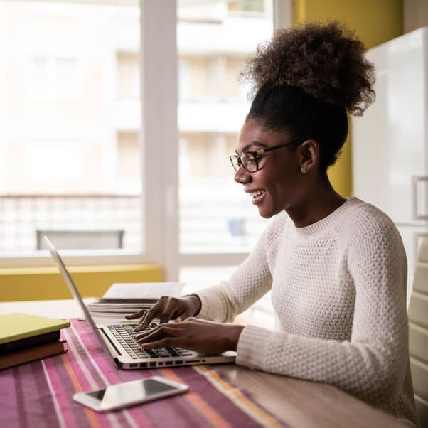 Person sat at a desk using a computer.
