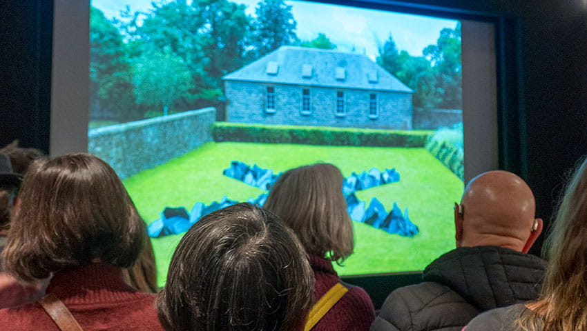 Guests in front of screen at Richard Long event for Bristol Distinguished Address Series, November 2024.