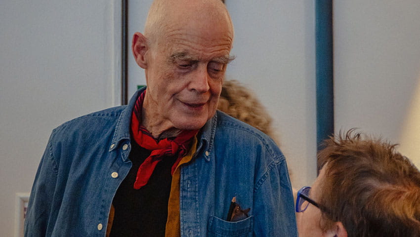 Richard Long chatting with guest at Bristol Distinguished Address Series, November 2024.