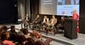 A panel of people on stage at the BDAS event