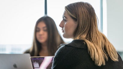 A finance student listening to a lecture.