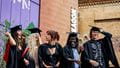 A line of graduates in robes outside the Bristol Beacon.