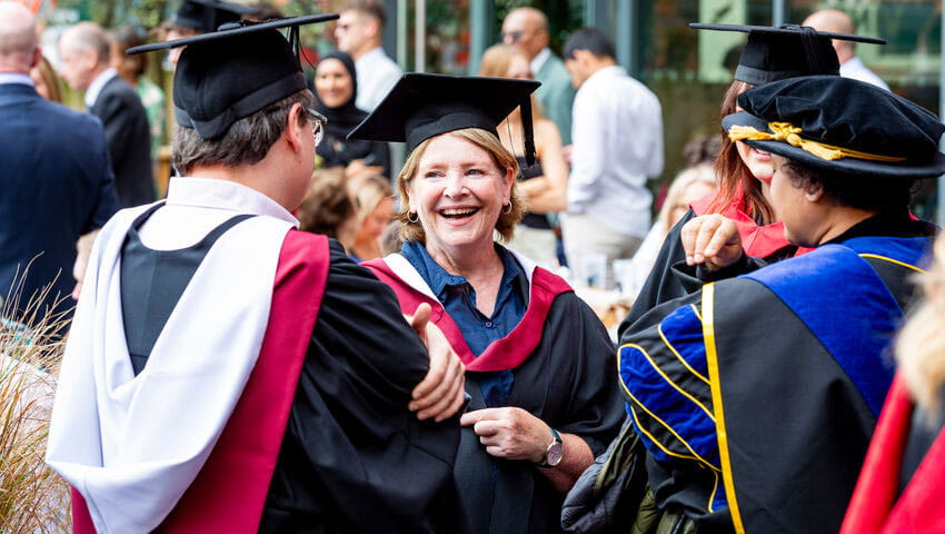 Graduates laughing outside the Bristol Beacon.