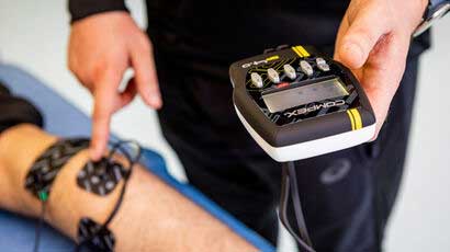 Close up of a someone looking at a digital monitor which is attached to another persons arm.