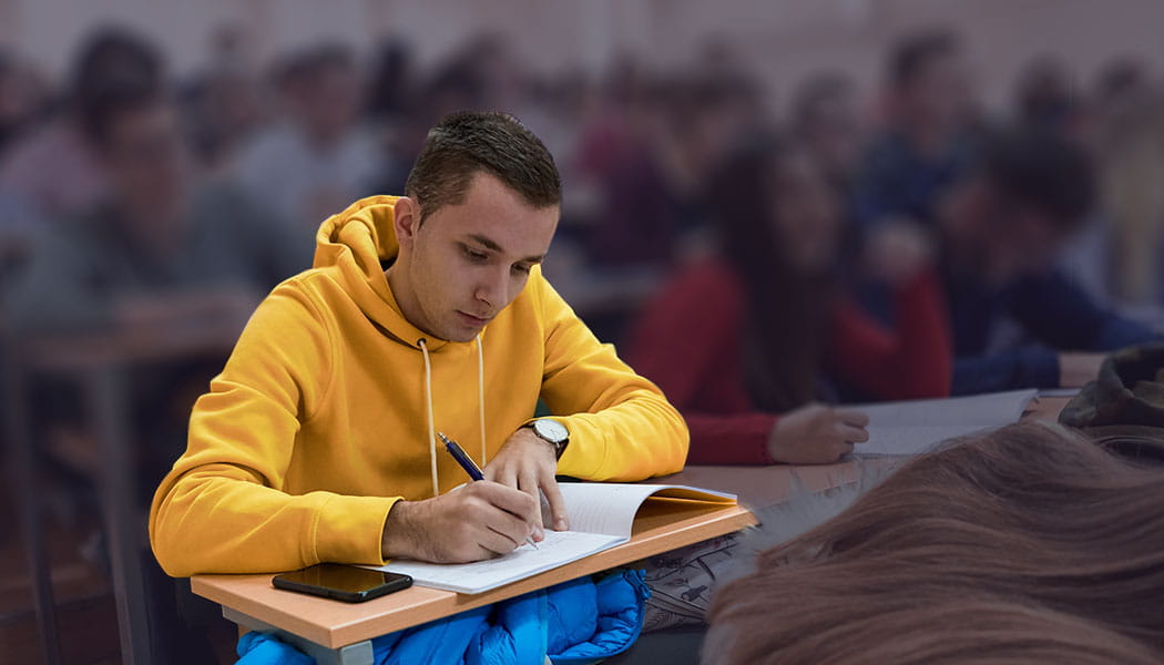 Student taking notes in lecture