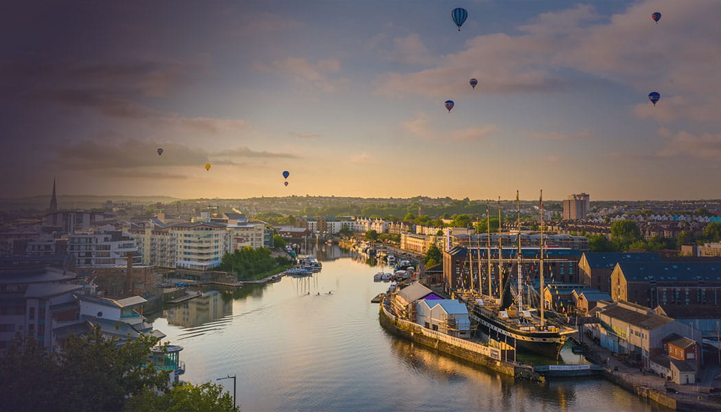 Cityscape of Bristol with hot air balloons in the sky