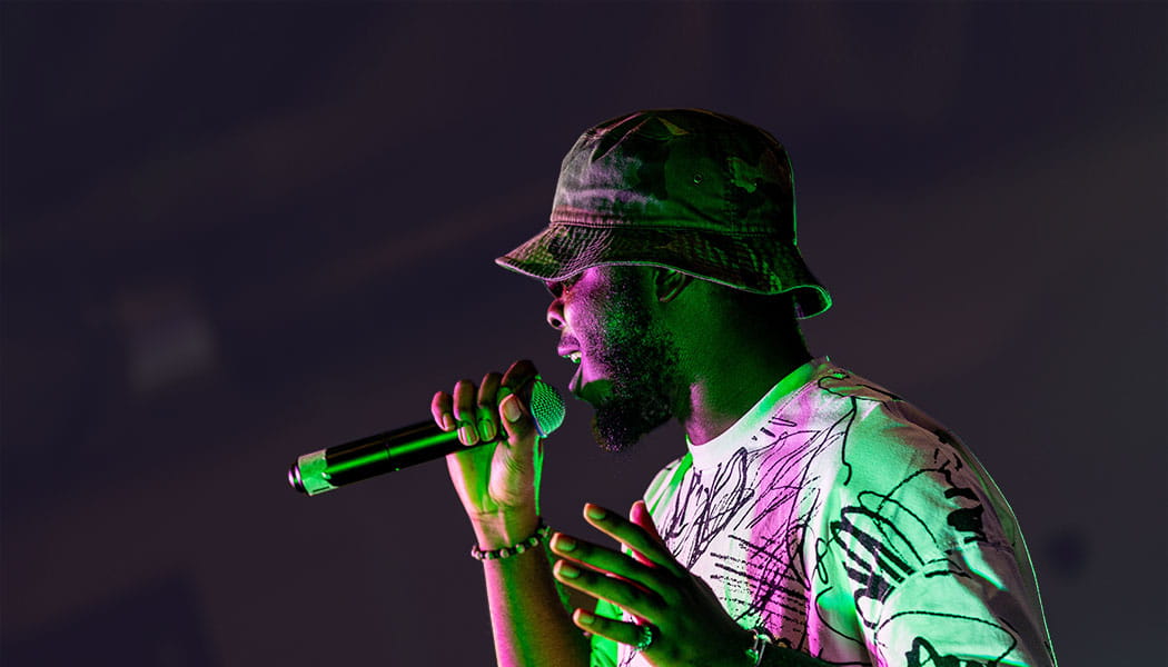 Black male singing into microphone