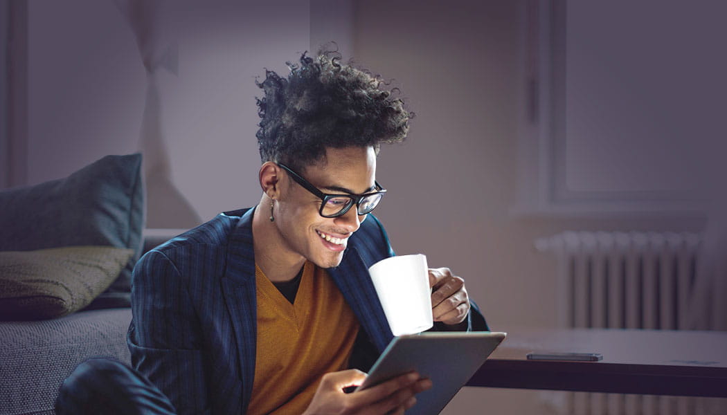 Smiling man viewing an iPad 