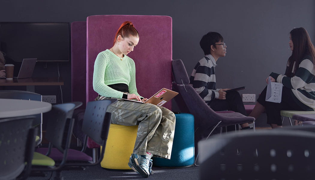 Student with a laptop in a UWE café bar