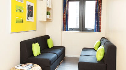 Communal area with sofas and bulletin board in Cherry Court accommodation.
