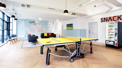 Communal area in Phoenix Court with a ping pong table and sofas.