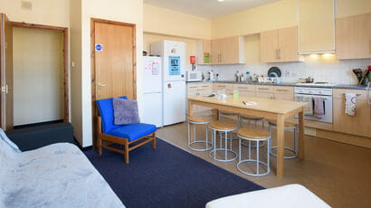A shared kitchen and communal area in the Hollies, fully equipped with seating area.