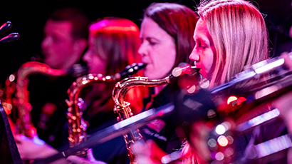 image of 4 young people playing saxophone