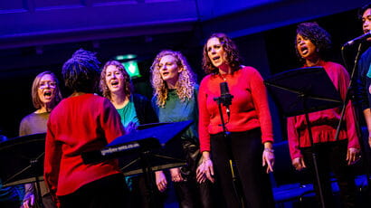 A group of singers singing on stage