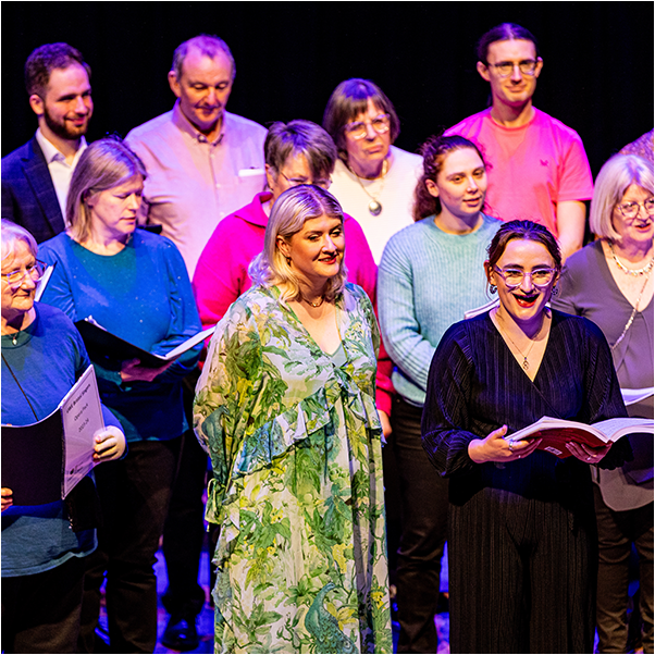 A group of people singing on stage
