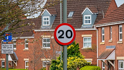 Photo shows a 20 mile per hour road sign in an urban environment in Wales