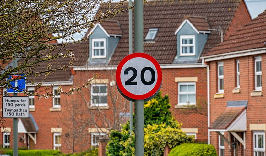 Photo shows a 20 mile per hour road sign in an urban environment in Wales