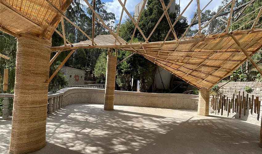 A large bamboo structure in a park pavilion