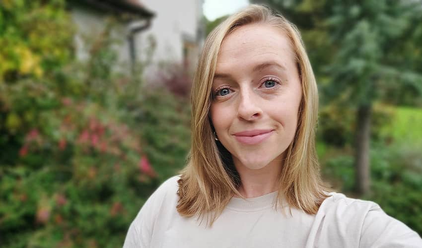 A women with shoulder length blond hair smiles at the camera