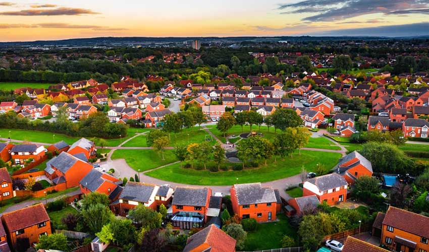 A new build housing estate with a circle of greenery in the centre