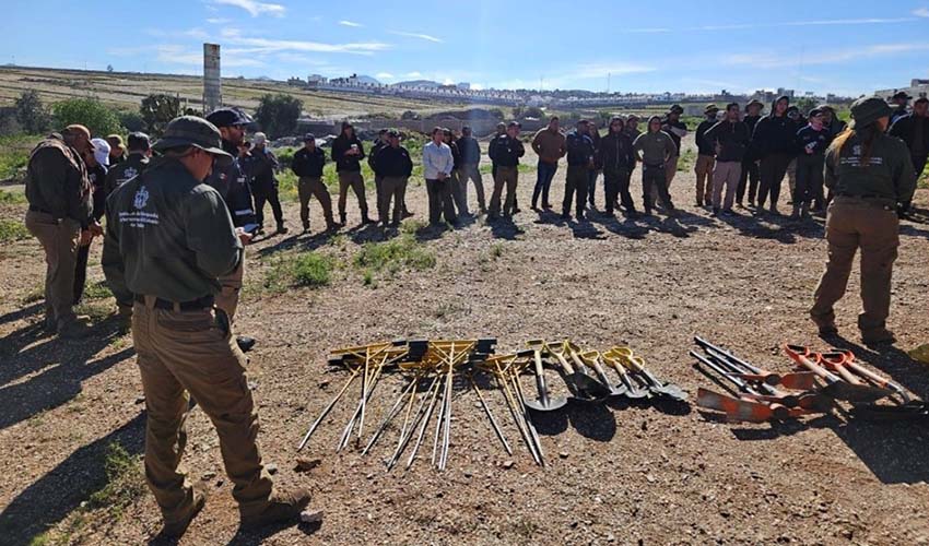 A image of people searching for graves in Mexico, with spades and other tools on the ground