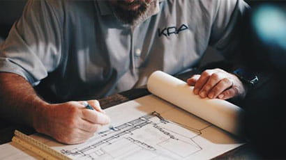 An architect drawing his design on paper