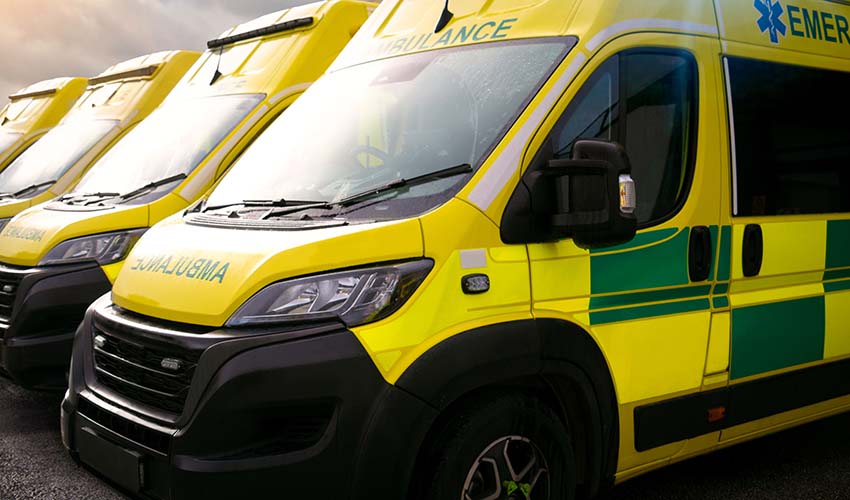 A line of yellow ambulances