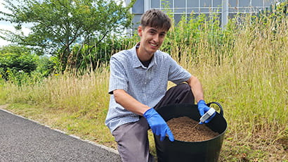A student at UWE Bristol is testing soil with a sustainable fertiliser made from urine. 