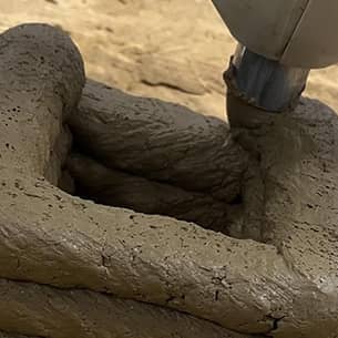 A close-up of a 3D printer building an object